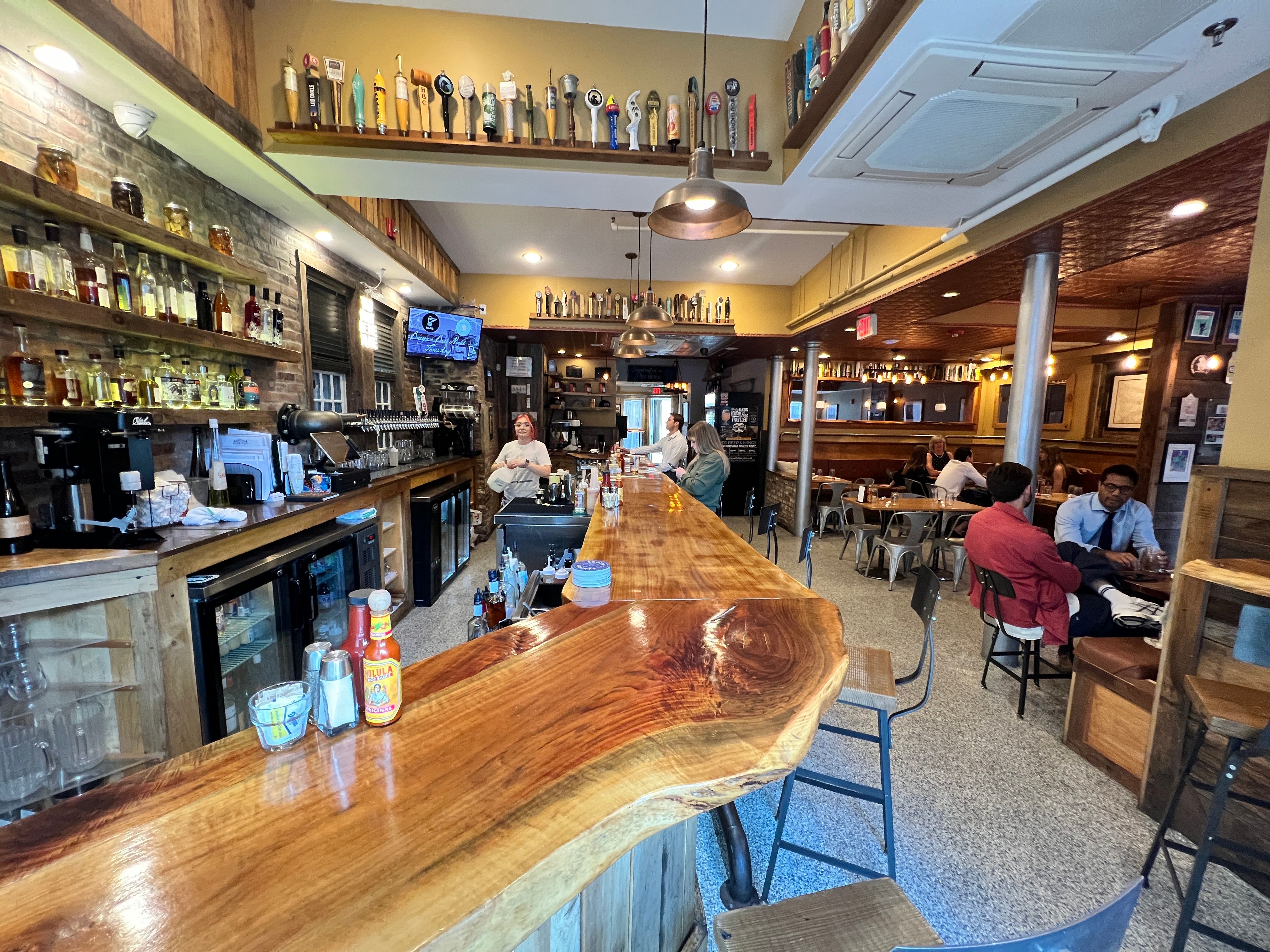 The finished live-edge bar at Rogue Island, taps and all