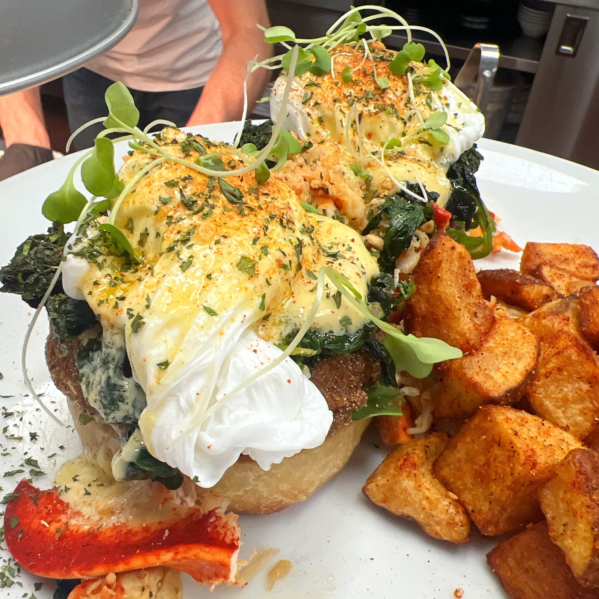 Cajun lobster benedict with poached farm eggs and home fries