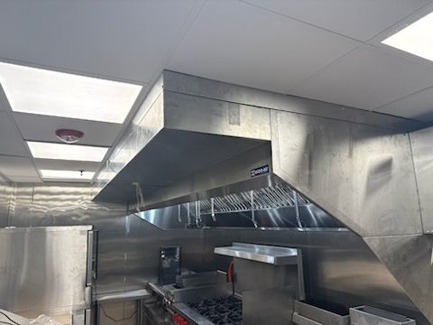 The kitchen exhaust hood being installed