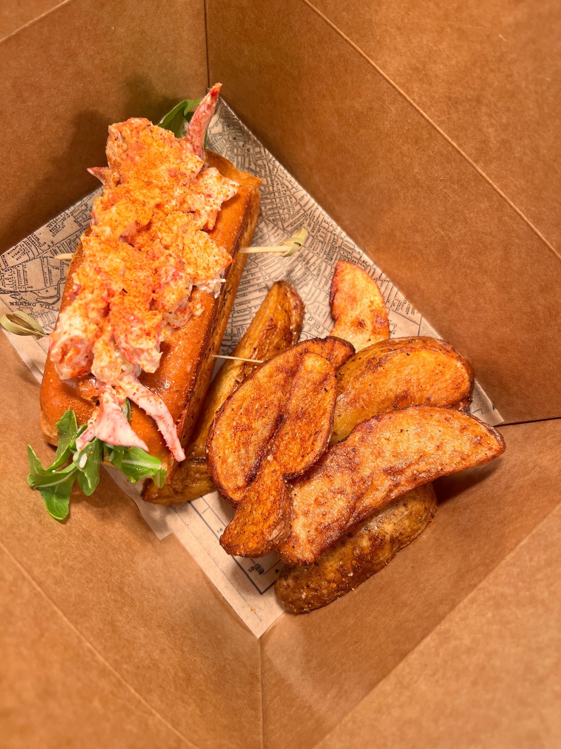 Rogue Island lobster roll packed in a to-go box