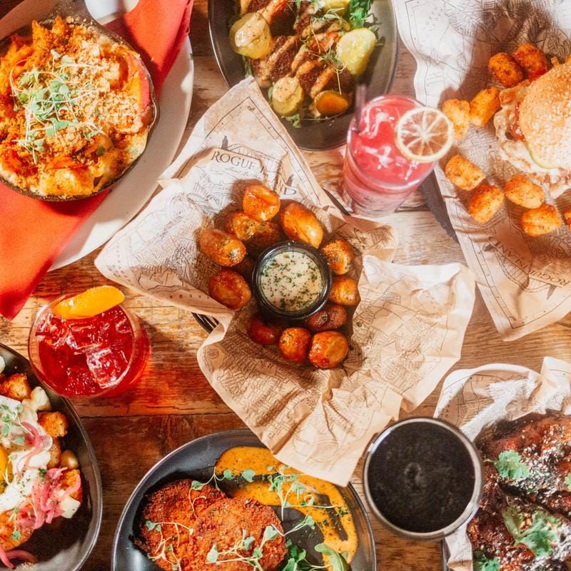 A full table of Rogue Island shareables and cocktails
